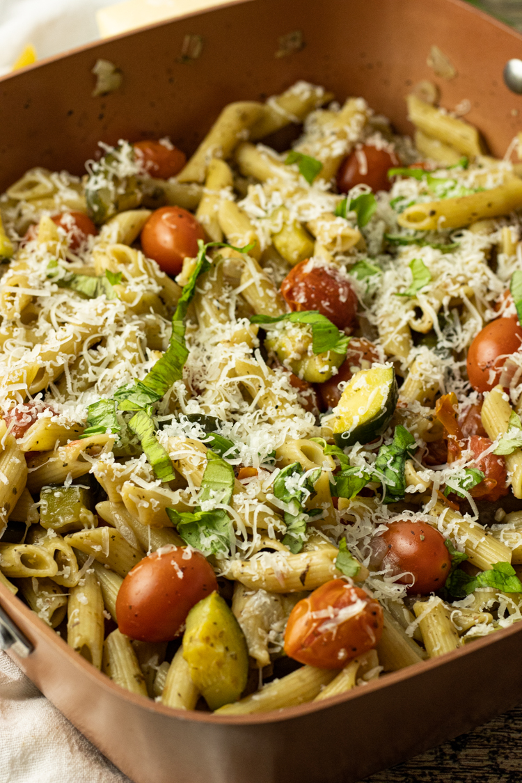 tomato pasta with fresh basil and grated cheese