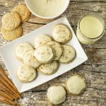 plate of eggnog cookies, with a cup of eggnog