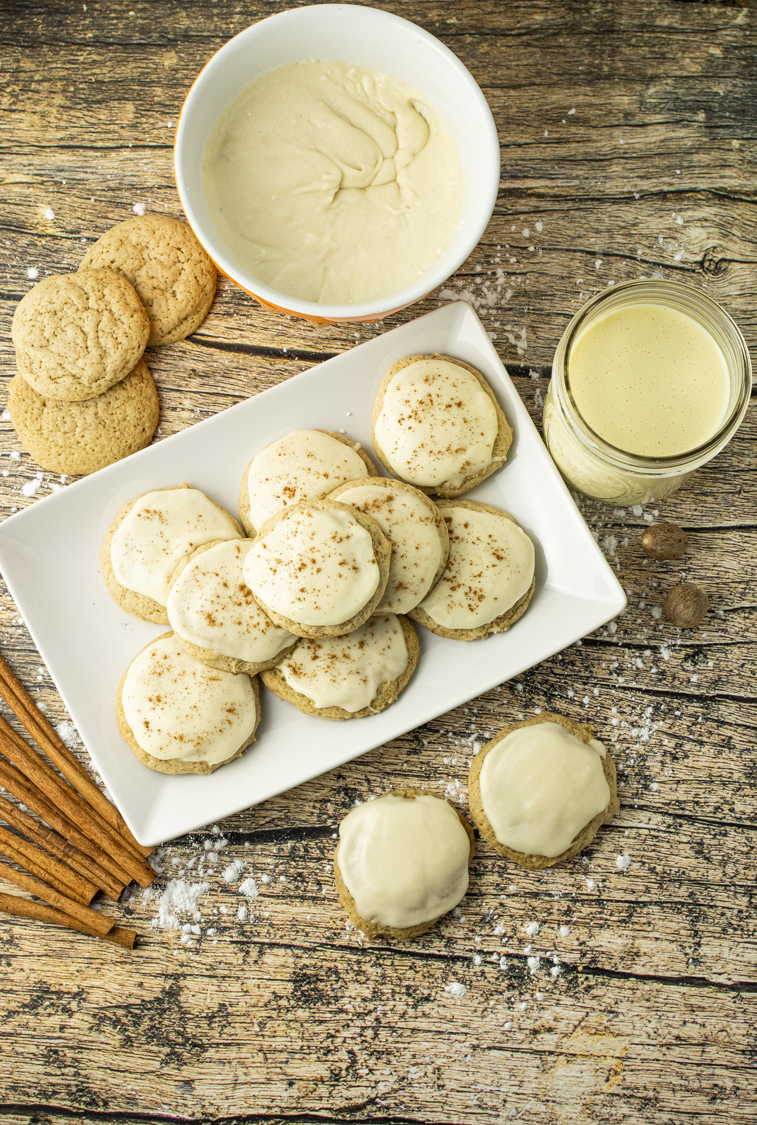 Eggnog Cookies are super soft, delicious cookies made with eggnog and loaded with delicious cinnamon and nutmeg flavor. This Eggnog Cookie recipe is simple to make and perfect for sharing with friends and family any time you can get your hands on some eggnog. The Eggnog frosting is the perfect topping for these festive cookies. #eggnog #eggnogrecipes #holidaybaking #holidayrecipes #cookieideas #christmascookies