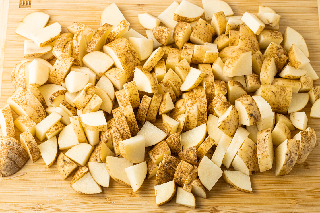 sliced potatoes on a wooden cutting board