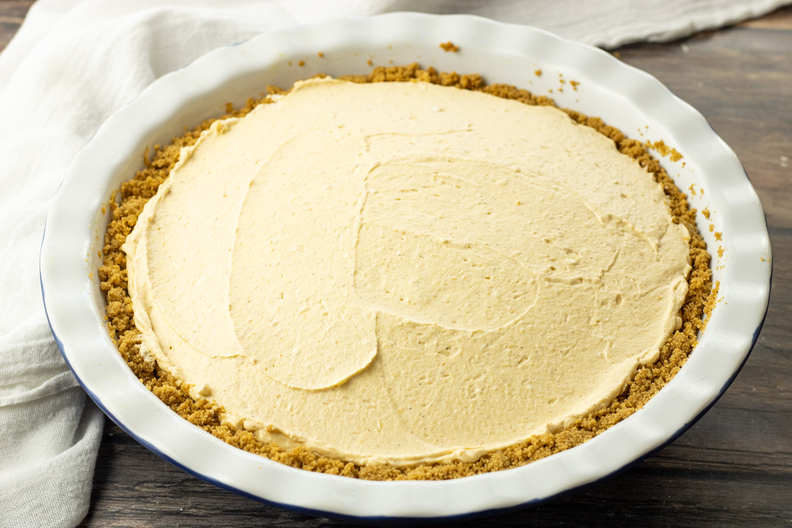 cream pumpkin pie in a graham cracker crust