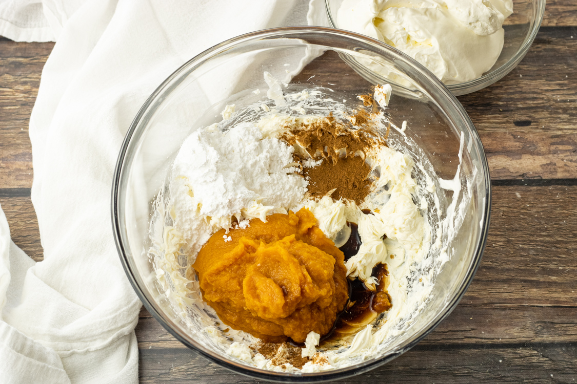 ingredients for pumpkin cream pie filling in a mixing bowl