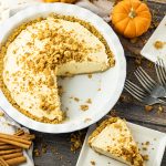pumpkin cream pie with a slice taken out onto a plate