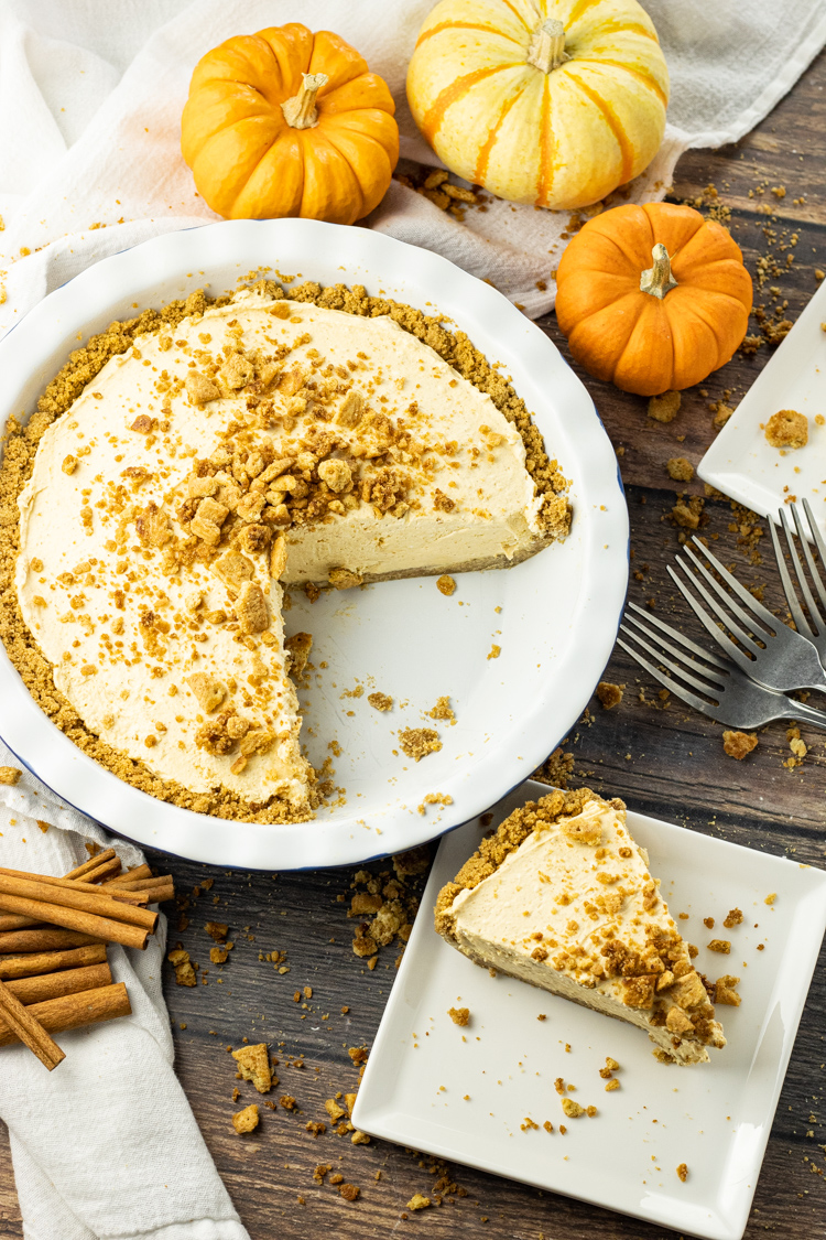 pumpkin cream pie with a slice taken out onto a plate