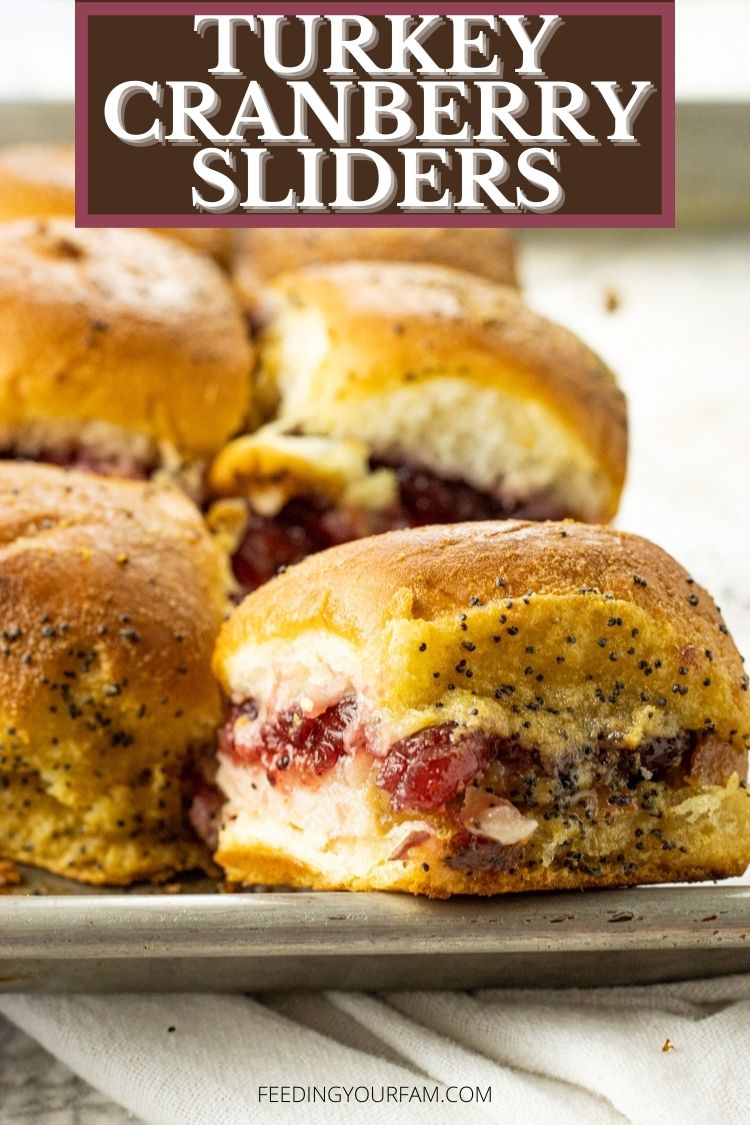 Turkey Cranberry Sliders are the perfect way to use up any leftover turkey. Layers of turkey, provolone cheese and cranberry sauce baked in a buttery sauce make for the perfect after Thanksgiving snack. #thanksgiving #leftoverturkey #turkeyrecipes #turkeysandwich #thanksgivingrecipes