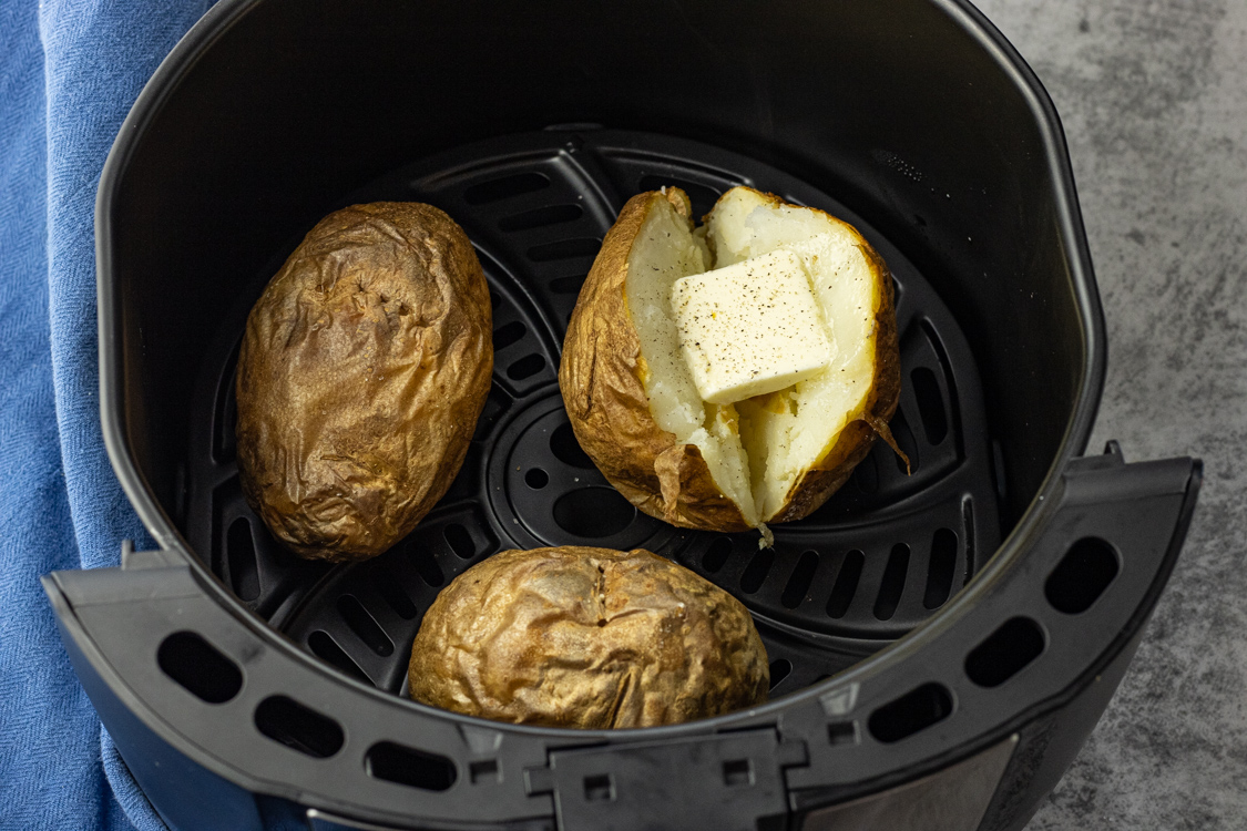 baked potatoes in an air fryer basket