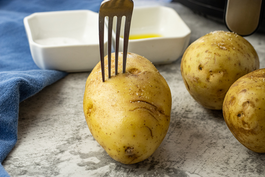 poking wholes in potatoes with a fork