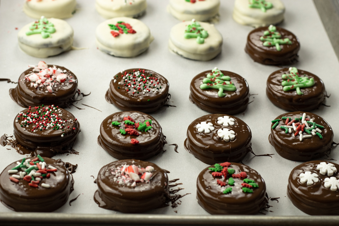 dipped oreos on a baking sheet
