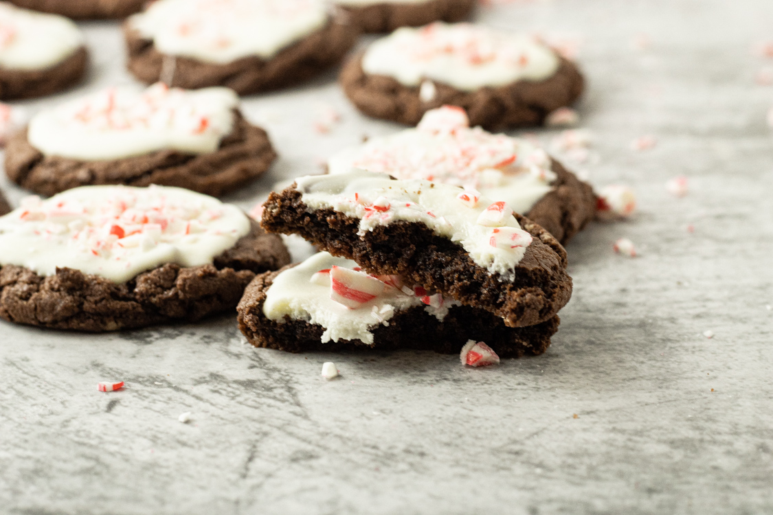 chocolate cookies with white chocolate topping and one cookie broken in half