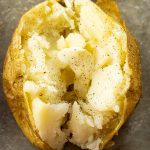 baked potato split in half with melting butter
