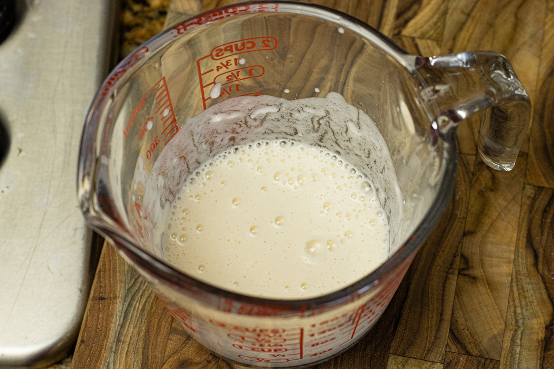 water and flour mixture in a measuring cup for thickening soup