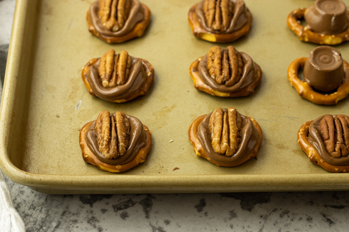 pretzels topped with Rolo candy and a pecan