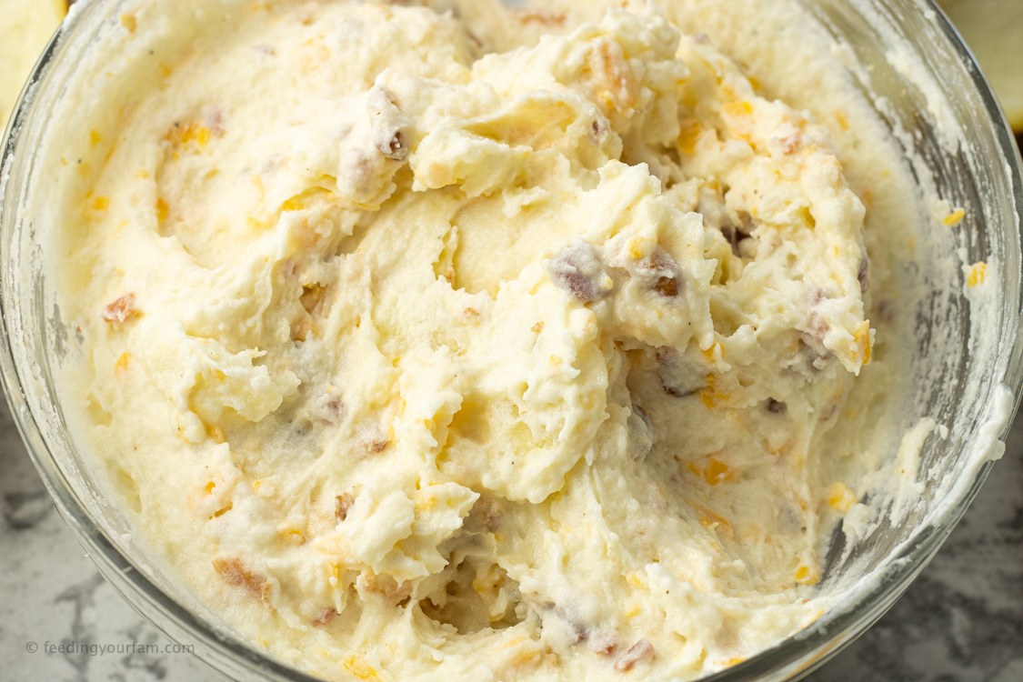 mashed potatoes with bacon and cheese in a bowl
