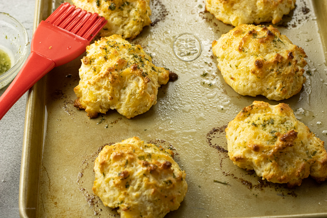 brushing butter on drop biscuits