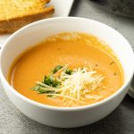 creamy tomato soup in a white bowl