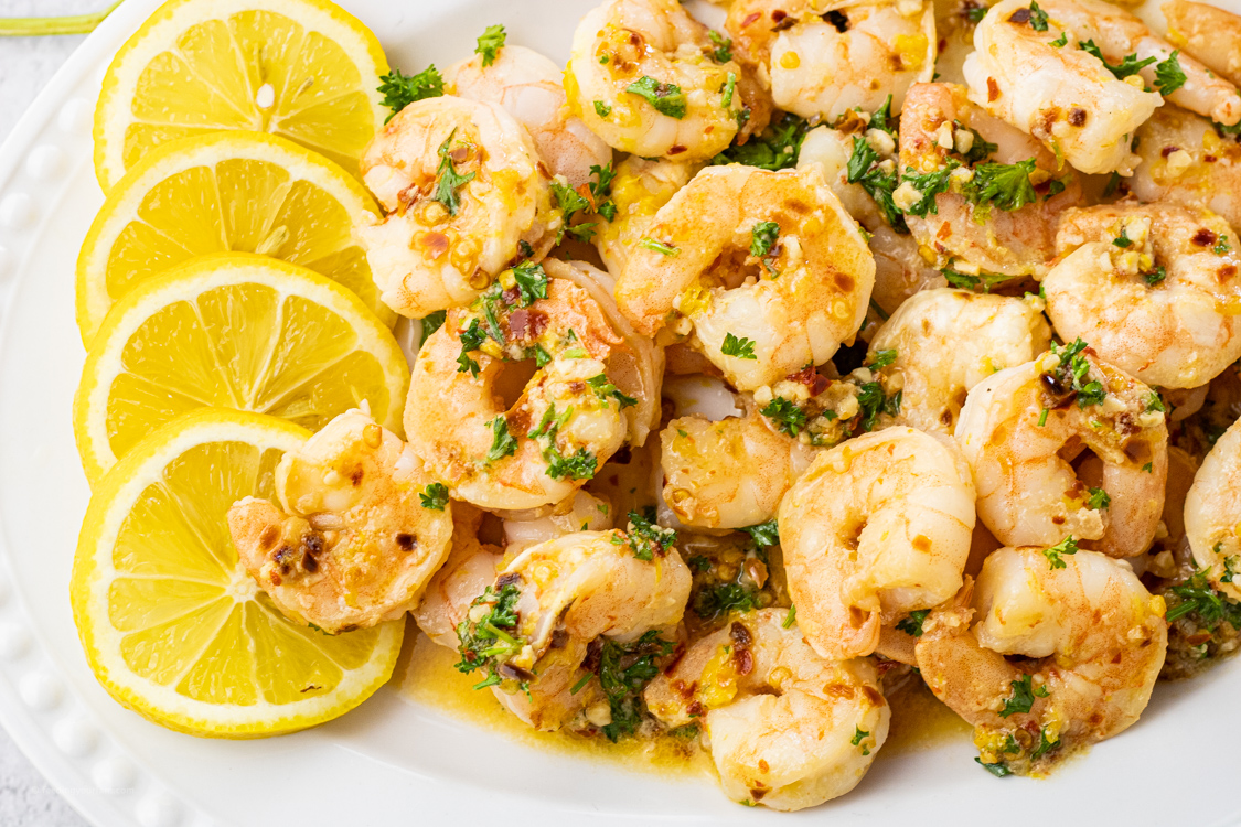 plate of shrimp covered with lemon garlic butter