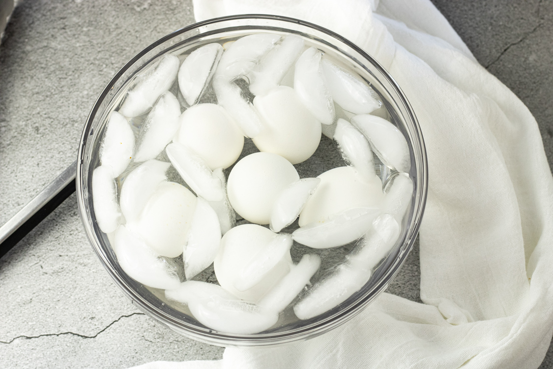 ice water bath with hard boiled eggs in it
