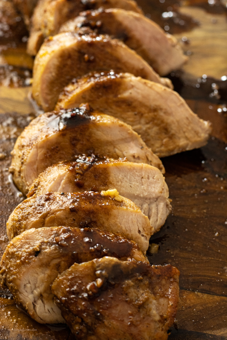 sliced pork tenderloin drizzled with balsamic vinegar