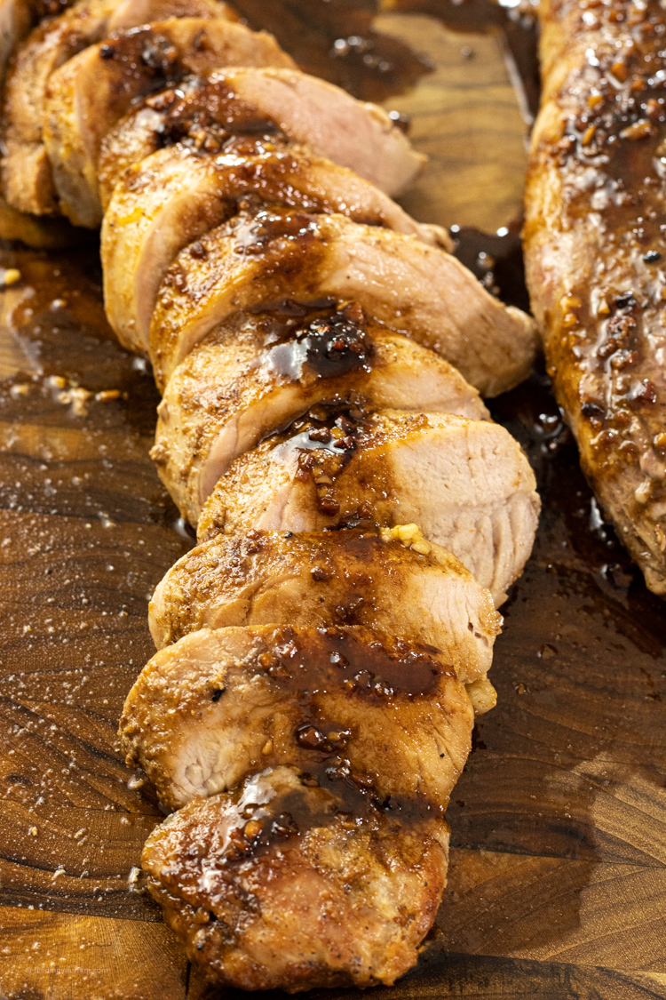 sliced pork tenderloin drizzled with balsamic vinegar