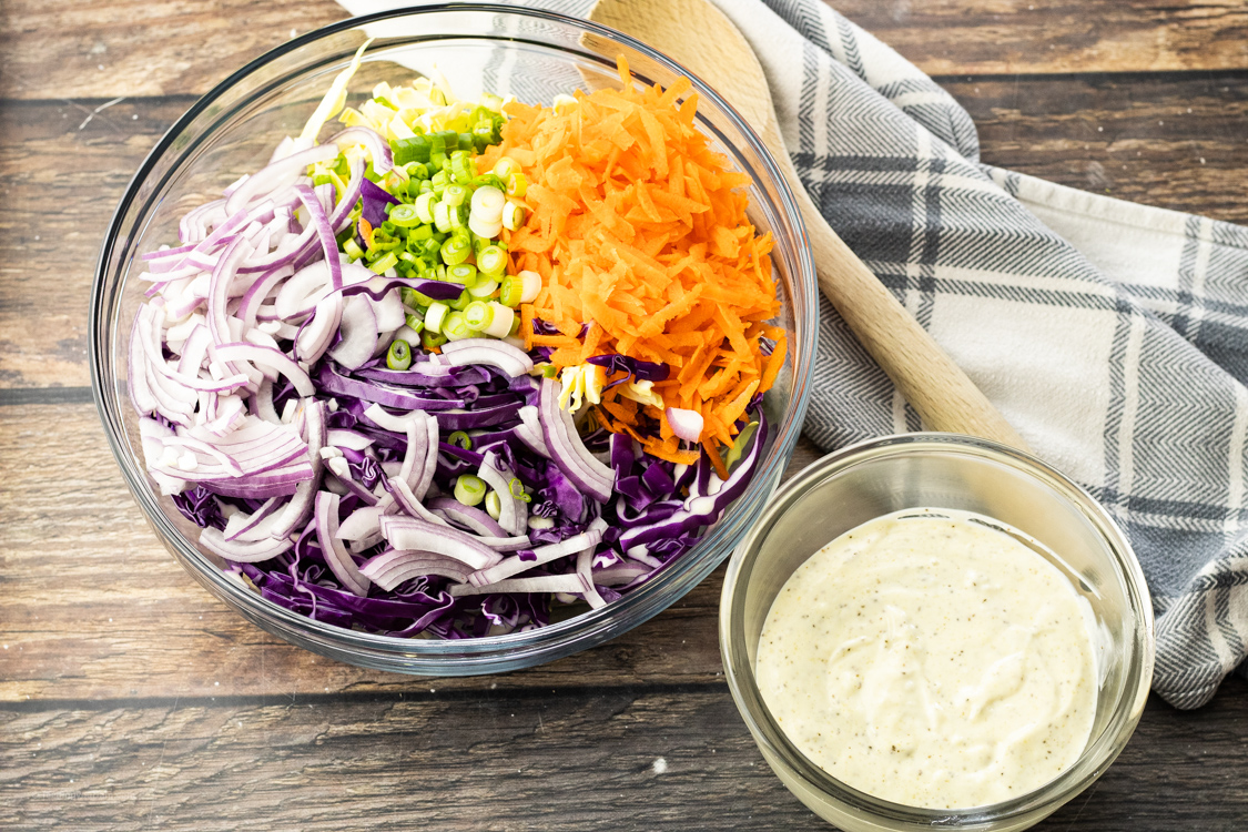 shredded cabbage, carrots and onions with coleslaw dressing