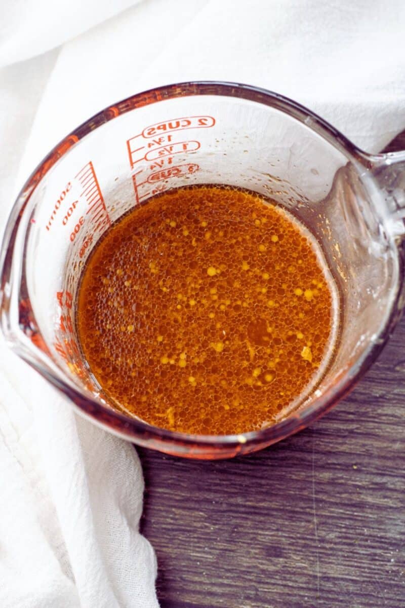 cup filled with a soy sauce stir fry sauce mixture 