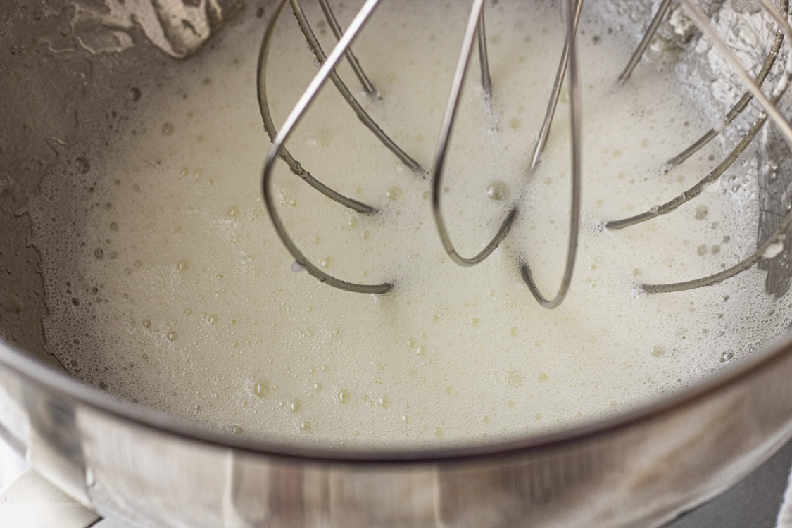 foaming egg whites in a mixing bowl