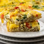 slices of breakfast pizza with eggs, sausage and cheese