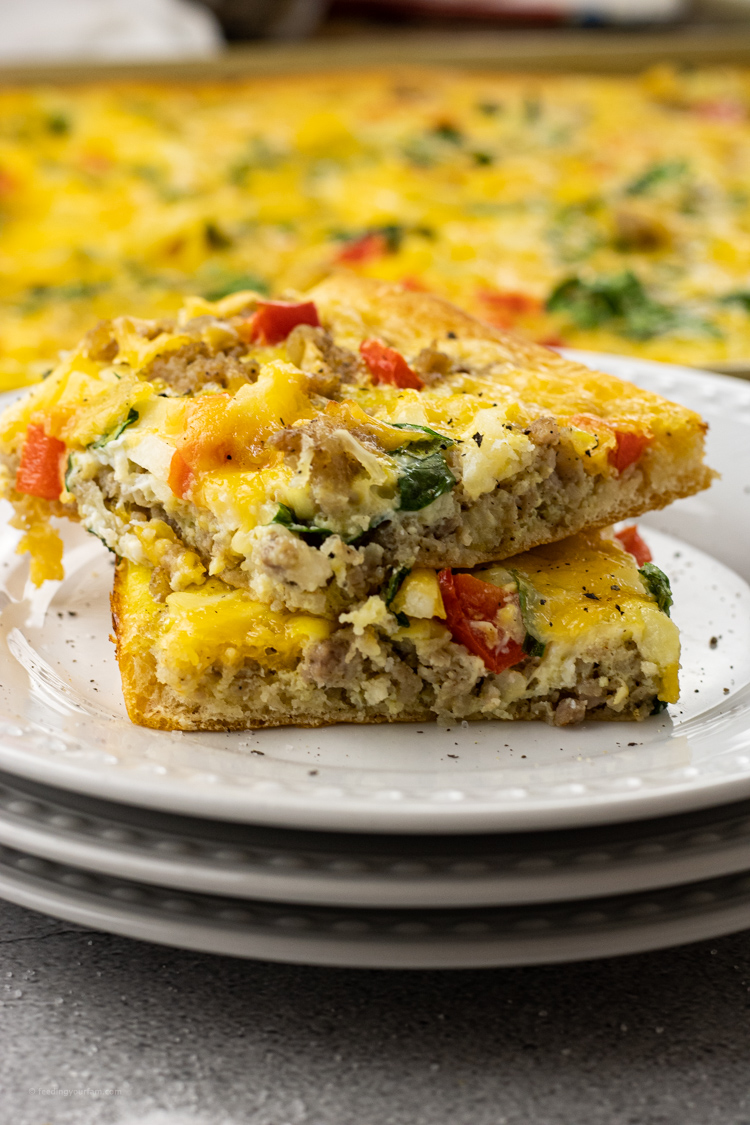 slices of breakfast pizza with eggs, sausage and cheese