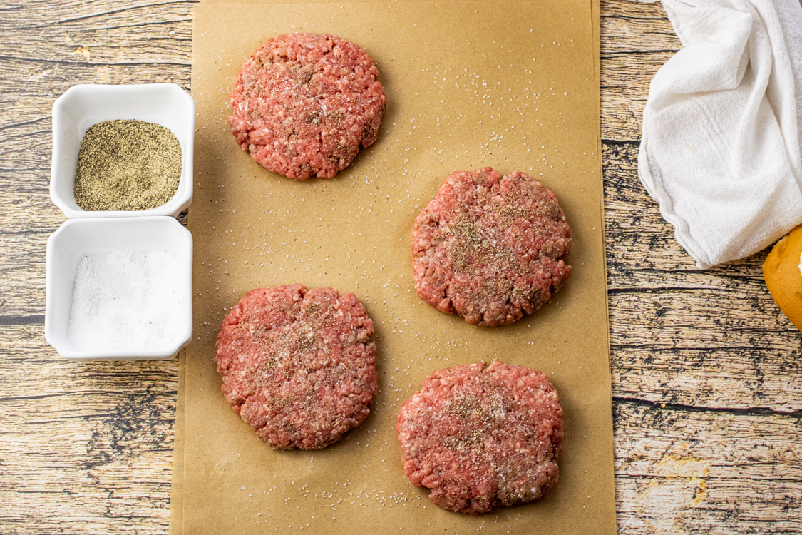beef patties on a piece of parchment paper