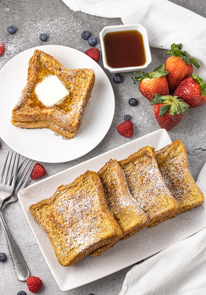pile of french toast on white plates