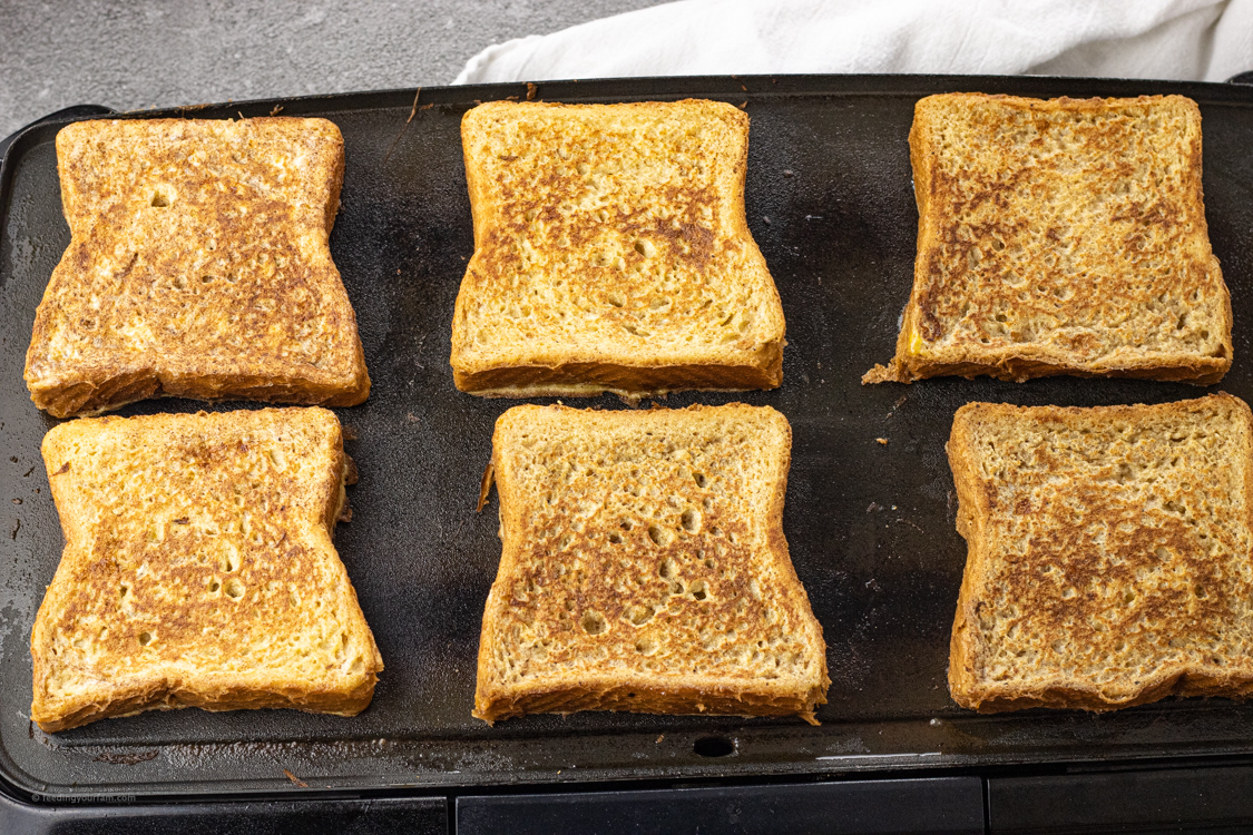 cooking french toast on a black skillet
