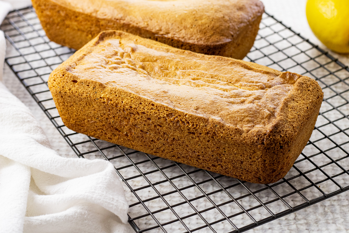 glazed loaves of lemon poppyseed bread on a cooling rack