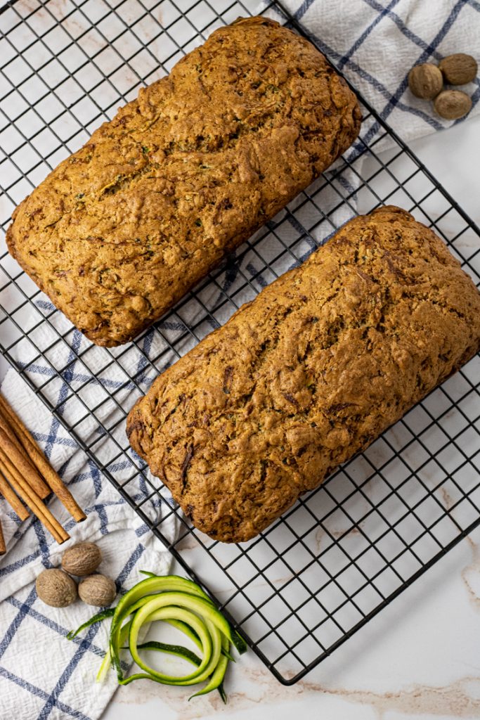 two loaves of zucchini bread on a cooling rack