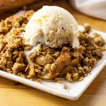 apple crisp topped with vanilla ice cream