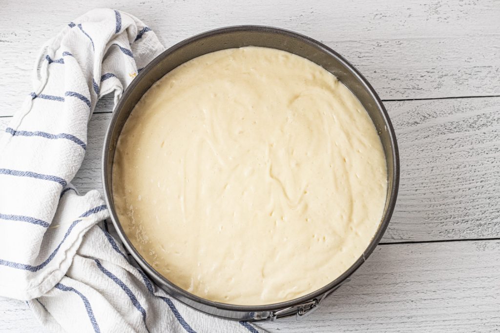 cake mix batter on top of fresh peaches in a round pan to make peach upside down cake