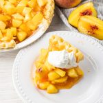 peach pie slice on a white plate