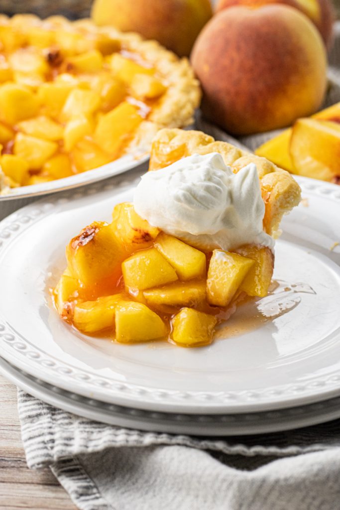 chopped peaches in a pie on a white plate