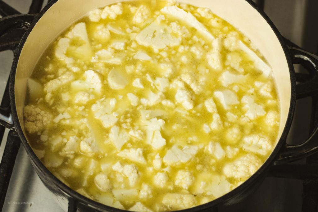 pieces of cauliflower in a dutch oven to make cheesy cauliflower soup