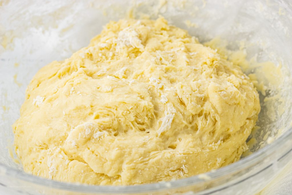 bread dough in a glass mixing bowl