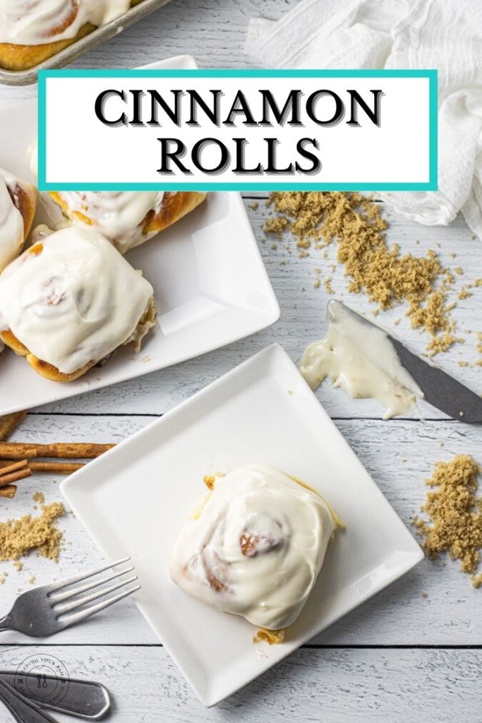 frosted cinnamon roll on a white plate