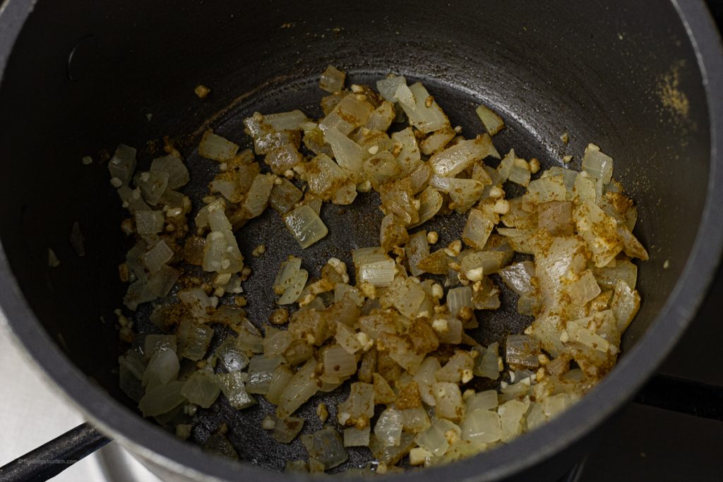 black pot with cooked diced onions and garlic