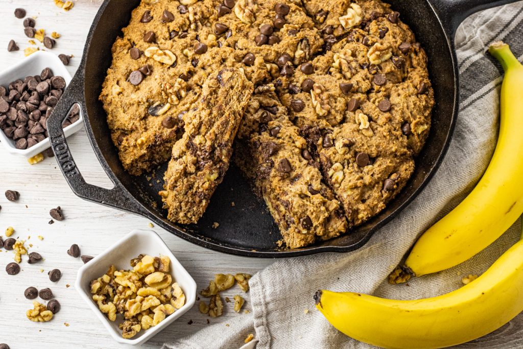 cast iron pan with sliced chocolate chip walnut banana bread