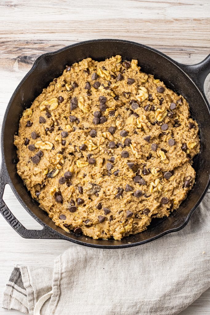 cast iron pan with chocolate chip banana bread batter