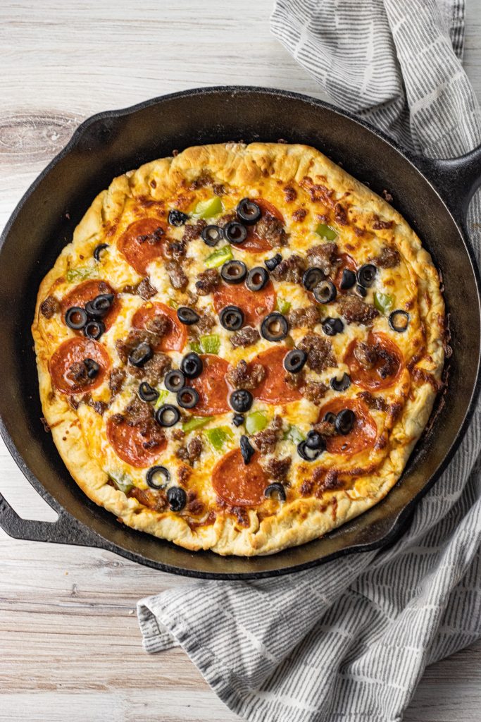 pizza cooked in a black cast iron pan