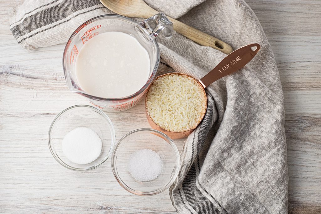 measuring cups with rice, coconut milk, sugar and salt