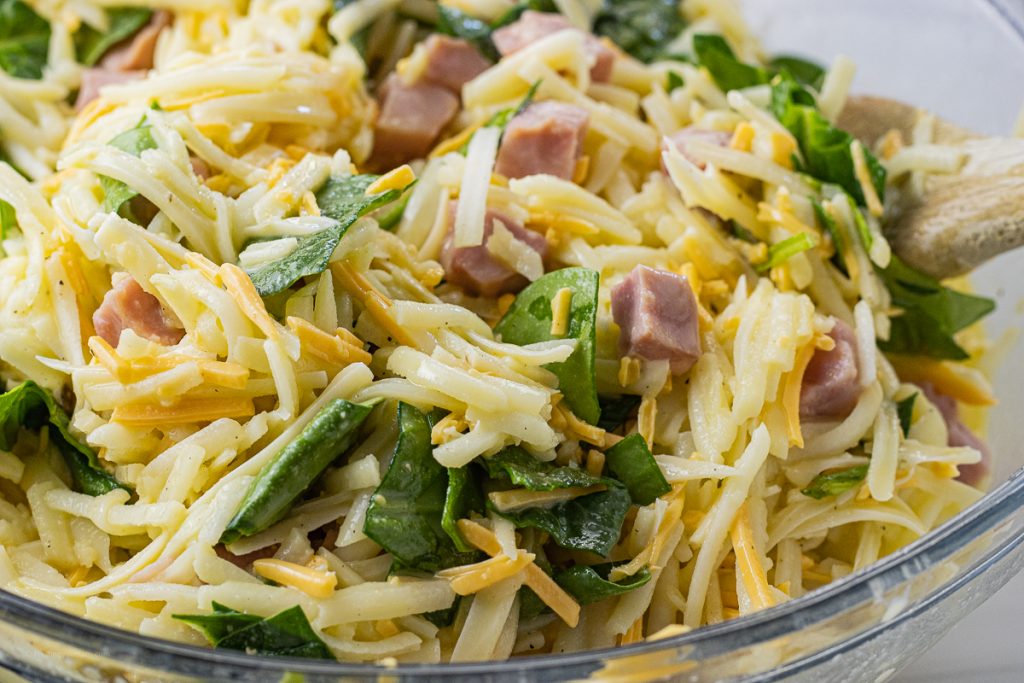 mixed together eggs, hashbrowns, ham, cheese and spinach