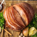 sliced ham on a wooden cutting board