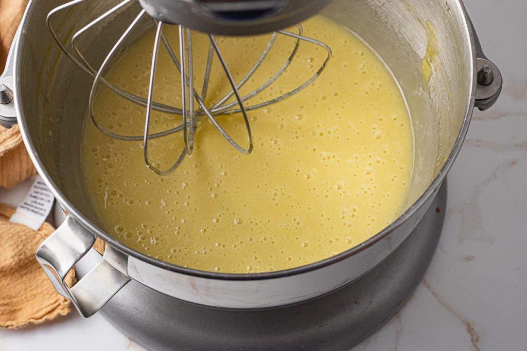 beaten eggs with oil and sugar in the bowl of a stand mixer
