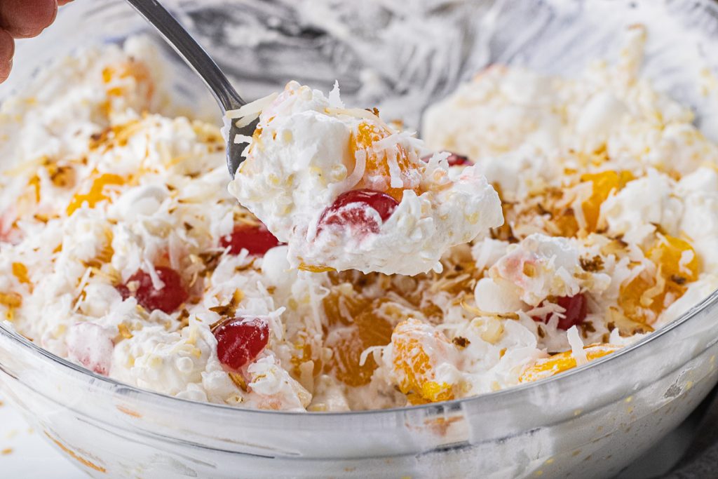 spoon scooping out a spoonful of fruit salad