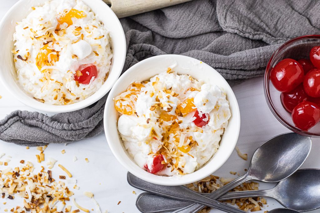 small bowl of fruit salad topped with toasted coconut